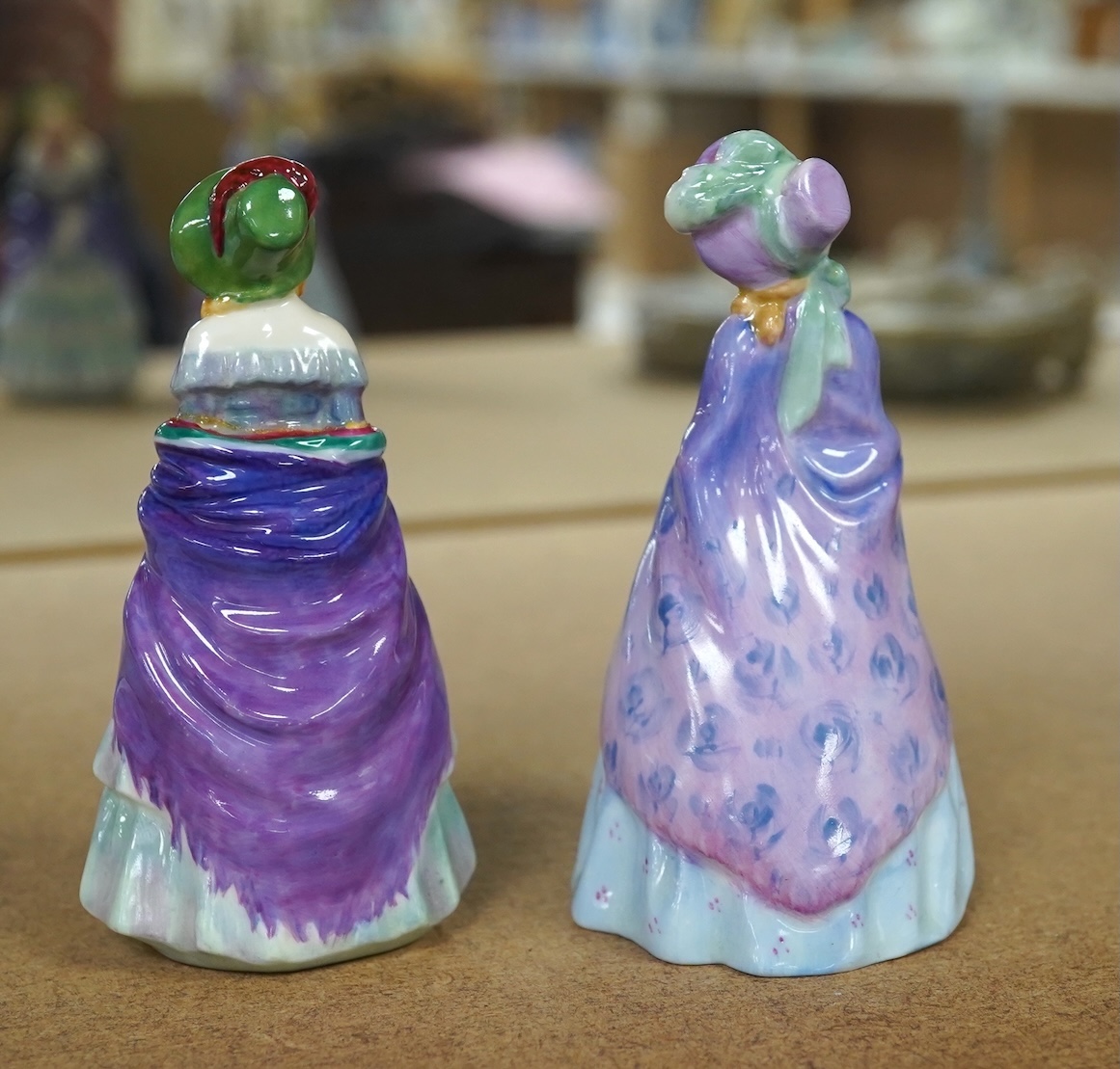 Two Royal Doulton M-series figures, M2 A Victorian Lady and M3 The Paisley shawl, 10cm high. Condition - one repaired